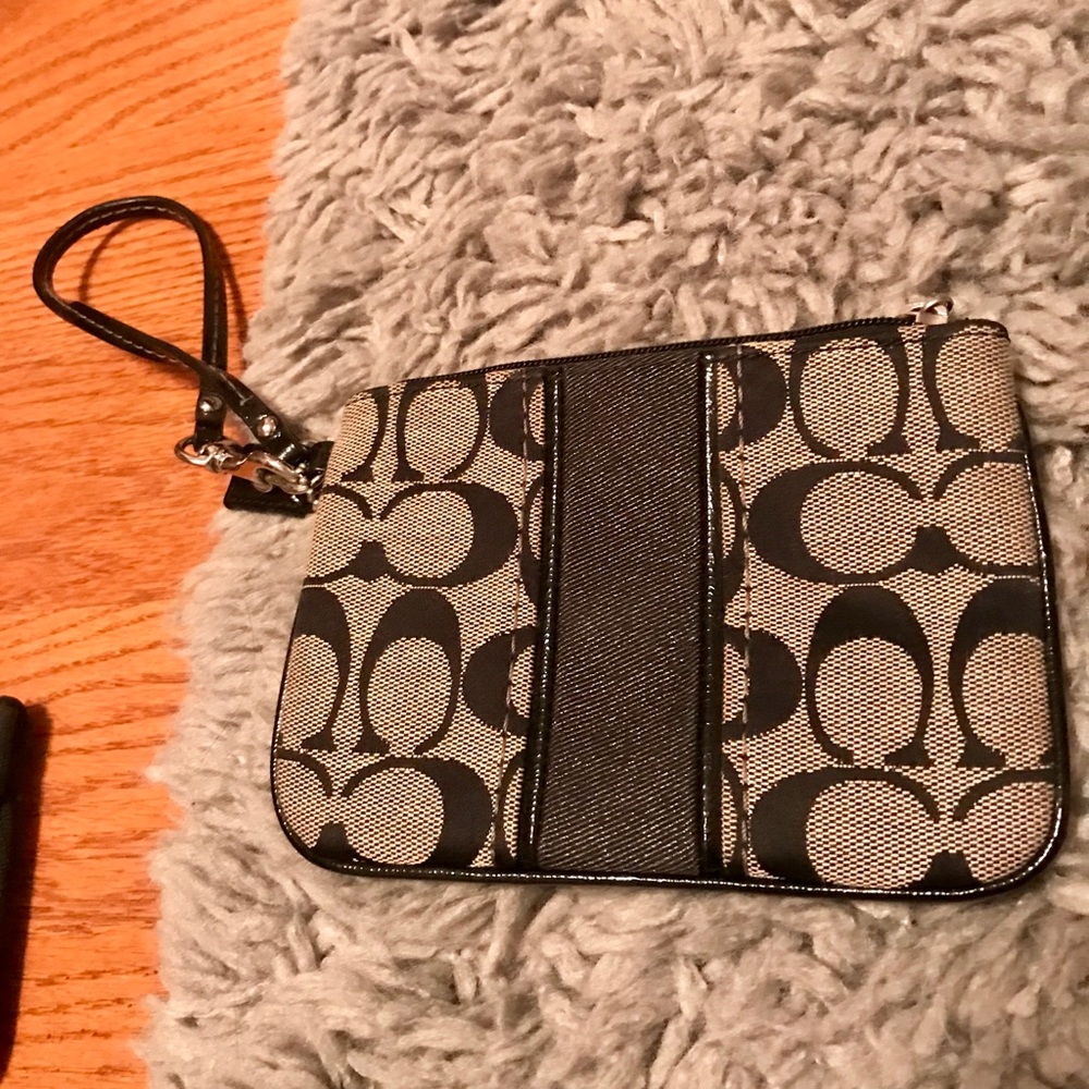 black patterned Coach logo wristlet